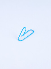 Blue  paperclip isolated on white background.