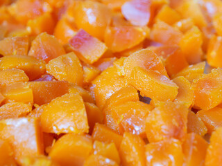 Egg yolks are cut into many pieces, bright orange, taken from the front.