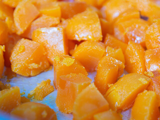 Egg yolks are cut into many pieces, bright orange, taken from the front.