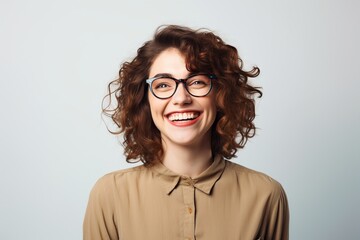 Fototapeta premium smiling happy laughing female wearing glasses with plain neutral background