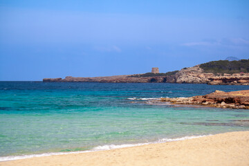 Far watchtower in the clear water shore