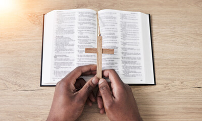 Bible, reading and cross with hands with book and religion study at home for worship and spiritual...