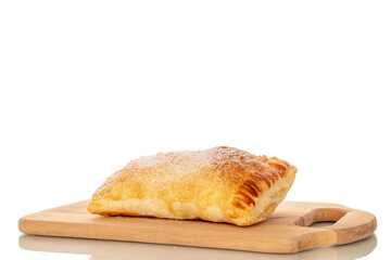 One aromatic puff pastry bun with apples on a wooden kitchen board, macro, isolated on white background.