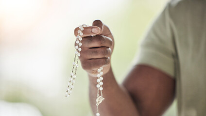Rosary, man hands and prayer beads in a home with hop, christian praise and religion. Praying,...