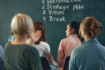 Performing, business and speaker with audience at office for learning. Coach and employees are training during meeting at company on board.