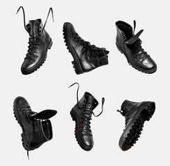 Black leather men's shoes with lace isolated on gray background. Military boots, hiking shoes, autumn winter unisex footwear. Minimalistic footwear Mock up. Cut out objects for design