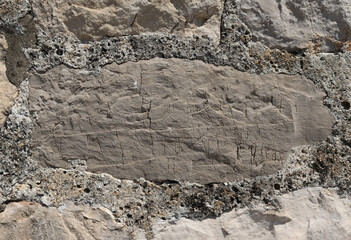 Detail of an old grey stone wall. Grunge background.  Selective focus