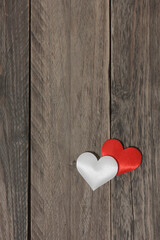 Love concept. Two hearts on a wood background.