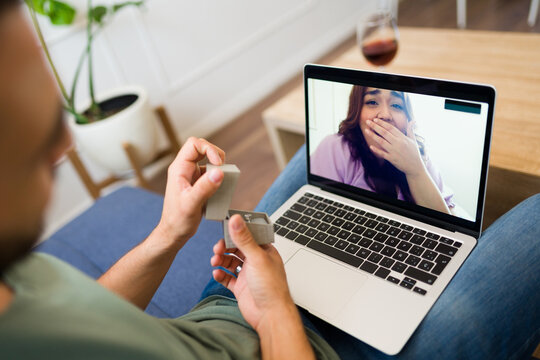 Long-distance couple getting engaged during a video call