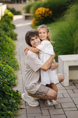 Fototapeta premium Portrait of happy and beautiful sister with her cousin. Adorable little girl and handsome teenage boy