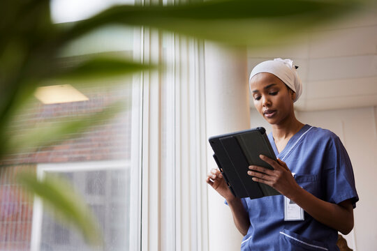 Young female doctor using tablet at work