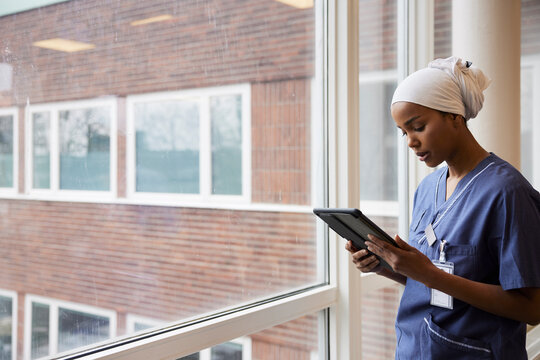 Young female doctor using tablet at work