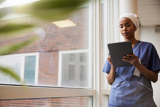 Young female doctor using tablet at work