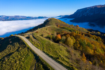 Fototapeta na wymiar Morning haze in the mountains. Aerial drone view of autumn countryside hills