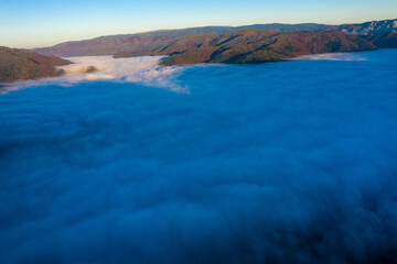 Aerial view of morning fog in the valley in dawn