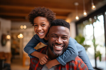 Happy African Black father having fun with teen boy at home.