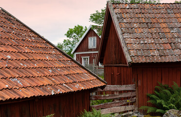 Typical  swedish village with red wooden houses in the landscape of Bråbygden in Småland, south-east Sweden.
