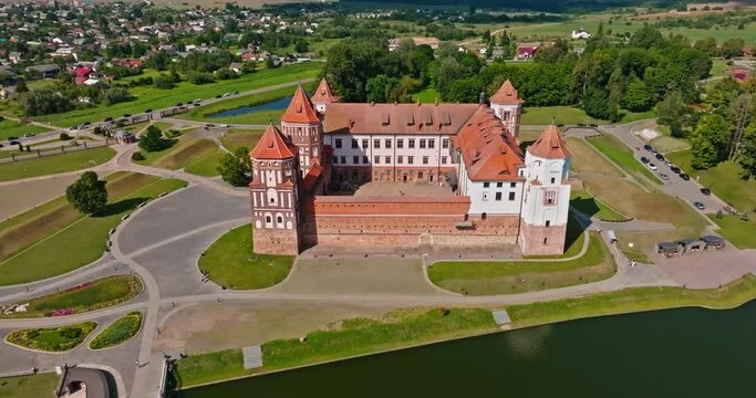aerial view and circular flight on overlooking restoration of the historic castle or palace near lake