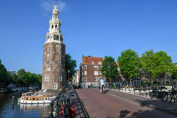 Fototapeta na wymiar Montelbaanstoren tower at a channel in the center of Amsterdam on Holland