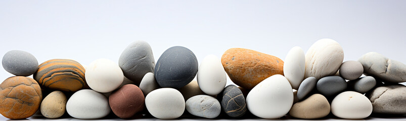 Fototapeta na wymiar Stones are arranged on a horizontal white background.