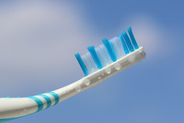 Toothbrush in sky background. Nylon bristles and plastic handles