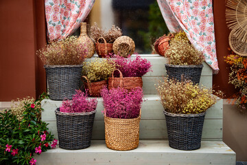 floral arrangement of dried flowers in wicker vase