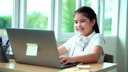 Kid girl smile enjoy e-learning on computer notebook with for laugh to funny communication and...