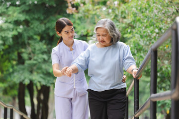 A nurse assisting an elderly patient in practicing walking by holding onto an iron railing is engaging in a common rehabilitation technique called gait training. 