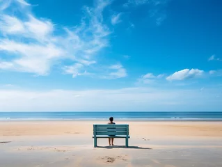 Crédence de cuisine en verre imprimé Coucher de soleil sur la plage A Person Sitting on A Wooden Bench on The Beach