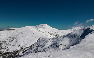 snow covered mountains and dark sky