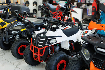 ATVs are sold in a motorcycle shop.