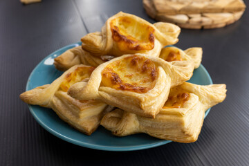 Puff pastry cheese square on black background.food concept. bakery.