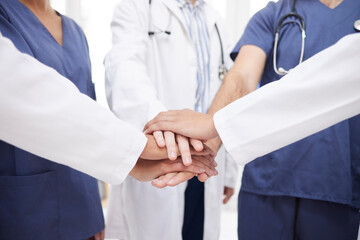 Doctor, teamwork and hands together in meeting, motivation or unity in healthcare mission together at hospital. Closeup of professional medical group piling in team building, support or clinic goals