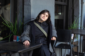 Portrait of a Woman sitting in a coffee shop/ vintage clothes on
