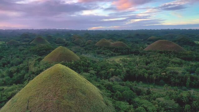 Chocolate Hills at sunset in Bohol, Philippines. Aerial view. Cinematic drone shot panning down at famous landmark travel destination.