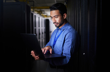 Man, server room and laptop of programming, system management and data center solution or coding at...