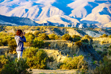 Woman take photos from Tabernas desert in Spain