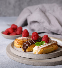 eclair cakes with chocolate icing and berries
