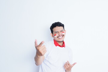 Indonesian man showing excitement with thumbs up when celebrating Indonesia independence day