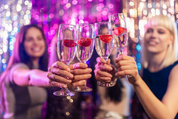 Portrait of girls's drinks at the club. Drinking alcohol
