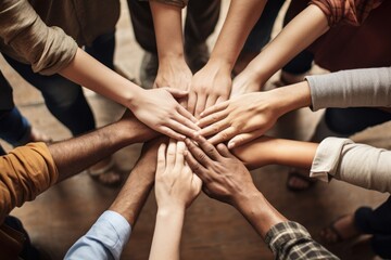 A photo of a group of people holding hands in a circle. Concept of team support.
