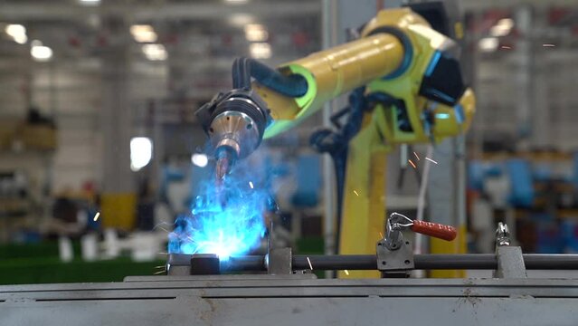 Robot works welding in a factory.  Automated robot welding.