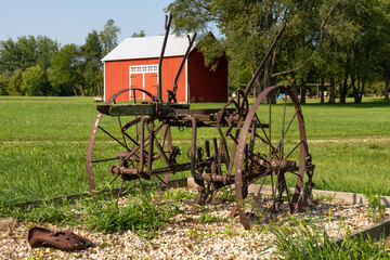 Old red barn and rusty old farm equipment in rural Illinois.