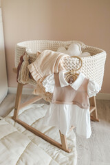Dress for a newborn girl on a wooden hanger in the nursery