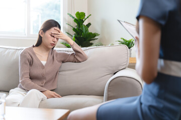Young woman in a mental therapy session talking with a psychologist in the office.