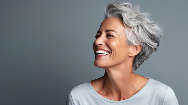 Beautiful gorgeous 50s mid age beautiful elderly senior model woman with grey hair laughing and smiling. Generative AI