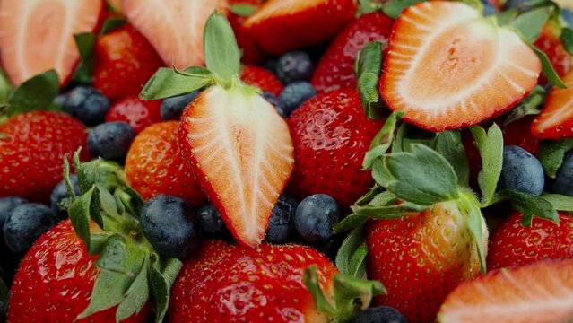 Red Strawberries, Pine Berry, and Hula Strawberry in a Bamboo Basket on Wooden Background
