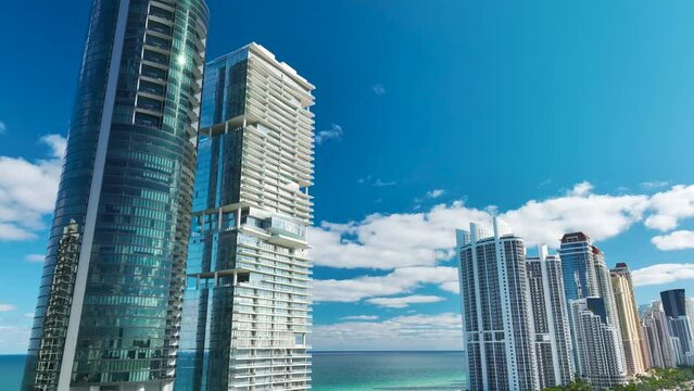 Sunny Isles Beach city with luxurious highrise hotels and condo buildings on Atlantic ocean shore. American tourism infrastructure in southern Florida