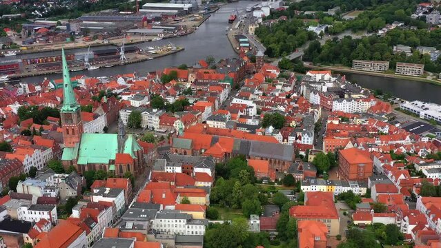Drone shot, drone video, drone flight, aerial view, flight over the historic city centre of Luebeck with a view of the Gothic St. Jacobi Church, the castle with the castle gate, the river Trave and