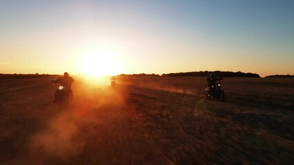 group of motorcyclists rides across the field, view of peoples, riding motorbike into sunset, driving across country road, free and happy, enjoy summertime, friends enjoy riding retro bikes